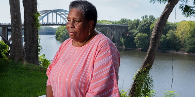 Joanne Bland sitting near the Edmund Pettus Bridge.