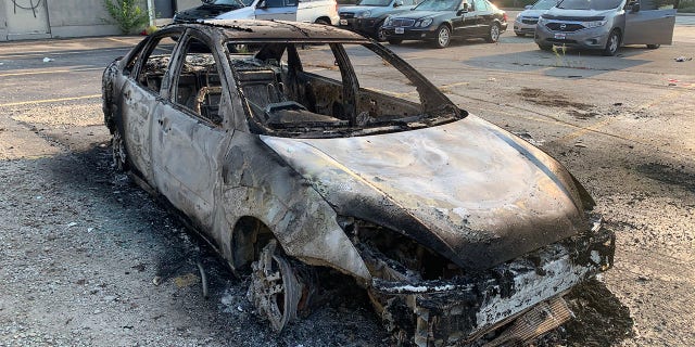 The damage in Kenosha includes many burned-out cars.