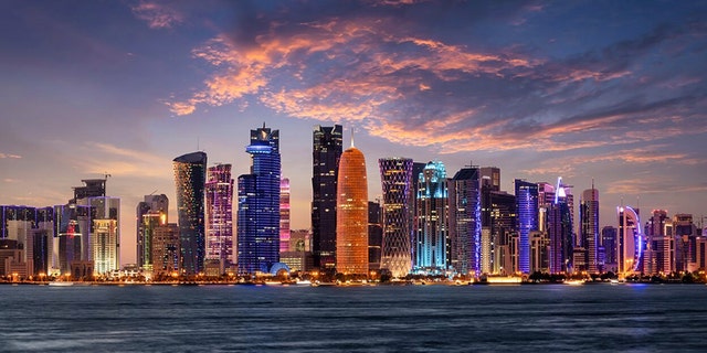 The illuminated, urban skyline of Doha, Qatar, with the modern skyscrapers just after sunset