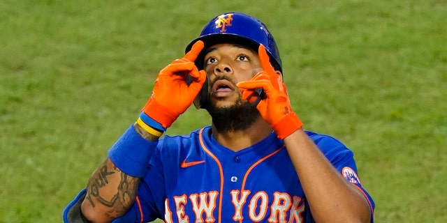 The New York Mets' Dominic Smith reacts after hitting a home run off Philadelphia Phillies pitcher Spencer Howard during the third inning of a game Aug. 14, 2020, in Philadelphia.