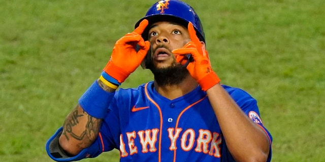 The New York Mets' Dominic Smith reacts after hitting a home run off Philadelphia Phillies pitcher Spencer Howard during the third inning of a game Aug. 14, 2020, in Philadelphia.