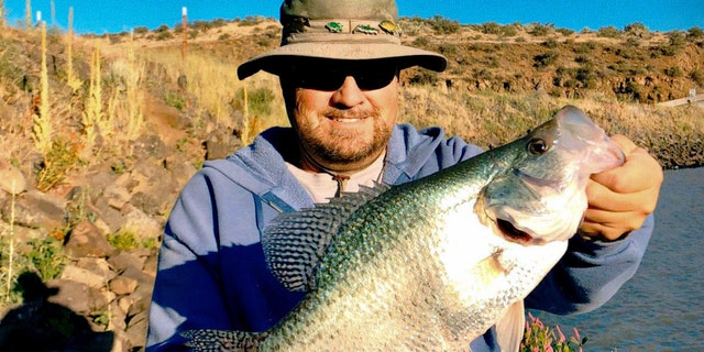 Jon Urban and his 17-inch black crappie fish, a record catch in the Gem State.