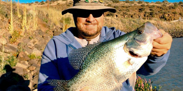 Jon Urban and his 17-inch black crappie fish, a record catch in the Gem State.