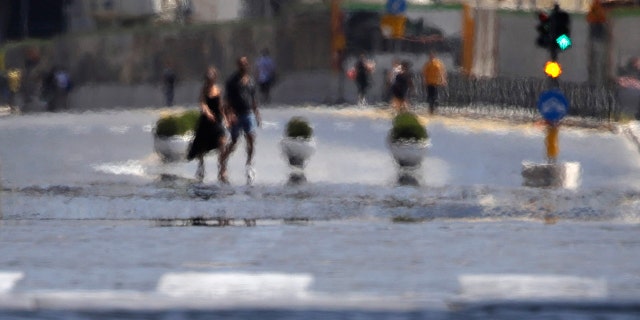 Optical effects caused by the heat on a road on a hot summer afternoon in Rome, Saturday, Aug. 1, 2020.