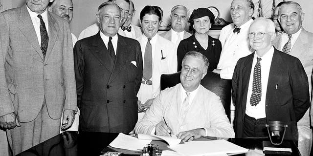 President Franklin Roosevelt signs the Social Security Bill in Washington on Aug. 14, 1935. (AP Photo)