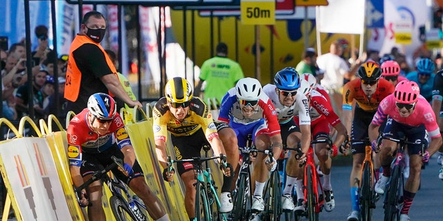 Sprinting for the win Dutch cyclist Fabio Jakobsen, left, hits side barriers at the start of a crash with his countryman Dylan Groenewegen, 2nd left, on the final stretch of the opening stage of the Tour de Pologne race in Katowice, Poland, on Wednesday, Aug. 5, 2020. (AP Photo/Tomasz Markowski)<br>