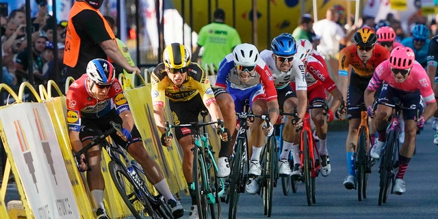 Sprinting for the win Dutch cyclist Fabio Jakobsen, left, hits side barriers at the start of a crash with his countryman Dylan Groenewegen, 2nd left, on the final stretch of the opening stage of the Tour de Pologne race in Katowice, Poland, on Wednesday, Aug. 5, 2020. (AP Photo/Tomasz Markowski)<br>