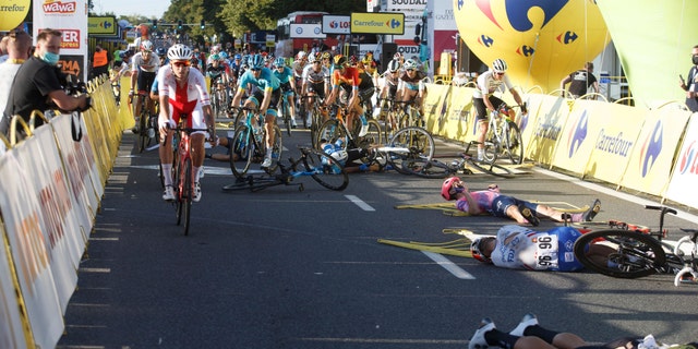 Cyclists are injured in a crash on the final stretch of the opening stage of the Tour de Pologne race in Katowice, Poland, on Wednesday, Aug. 5, 2020. (AP Photo)<br>