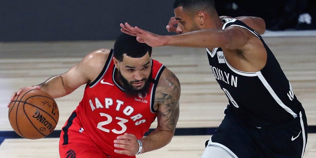 Toronto Raptors guard Fred VanVleet, left, drives against Brooklyn Nets guard Timothe Luwawu-Cabarrot, right, during the first half of Game 4 of an NBA basketball first-round playoff series, Sunday, Aug. 23, 2020, in Lake Buena Vista, Fla. (Kim Klement/Pool Photo via AP)