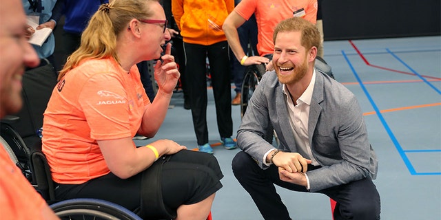 Prince Harry, Duke of Sussex speaks with athletes during a sports training session at Sportcampus Zuiderpark during a visit to The Hague as part of a program of events to mark the official launch of the Invictus Games.