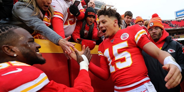Chiefs quarterback Patrick Mahomes and defensive end Frank Clark celebrate with fans after defeating the Los Angeles Chargers at Arrowhead Stadium on Dec. 29, 2019, in Kansas City, Missouri.