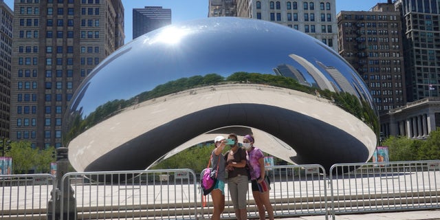 Visitors take pictures in front of the Cloud Gate sculpture in Millennium Park on June 15 in Chicago, Illinois. (Scott Olson/Getty Images)