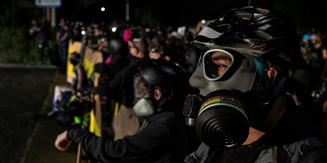 Protesters are seen at a standoff at a Portland Police Station in Portland, Ore., August 15, 2020 (Photo by Paula Bronstein / Getty Images)