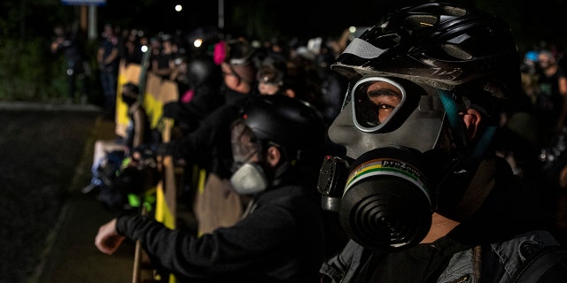 Protesters are seen during a standoff at a Portland police precinct in Portland, Oregon on August 15, 2020. (Photo by Paula Bronstein/Getty Images )