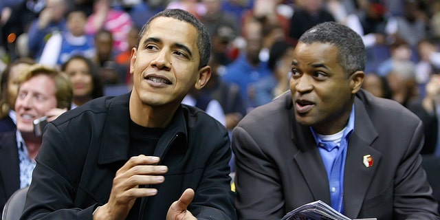 President Barack Obama talks with his friend Marty Nesbitt at the Chicago Bulls vs Washington Wizards basketball during their game played at the Verizon Center in Washington, D.C., Friday, February 27, 2009. (Photo by Harry E. Walker/MCT/Tribune News Service via Getty Images)