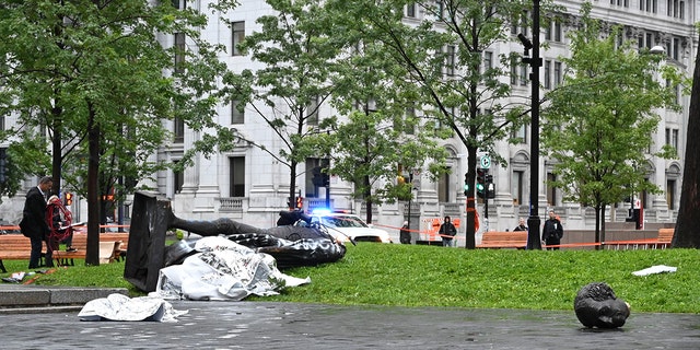A statue of the first Canadian Prime Minister John A. Macdonald lies on the ground (L), with the statue's head a few meters away, at Canada Park in central Montreal on August 29, 2020, after it was pulled down by anti-racism protesters during a demonstration calling for the defunding of the police. - Macdonald's government has been accused of seeking to assimilate indigenous peoples through forcible enrollment in residential schools, for example, that led to a loss of language and culture -- described in a 2015 reconciliation commission report as "cultural genocide." (Photo by Eric THOMAS / AFP) (Photo by ERIC THOMAS/AFP via Getty Images)