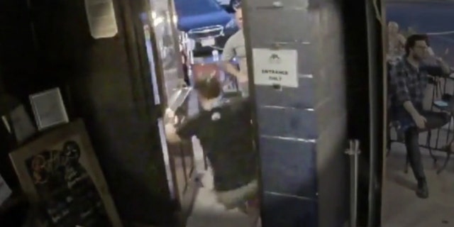 Images from the surveillance camera show the patron shoving the employee into a door jamb on Saturday night.
