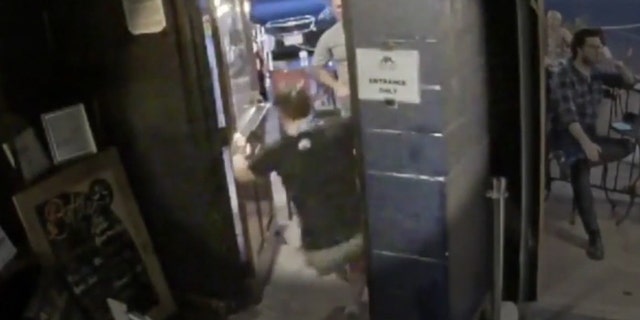 Images from the surveillance camera show the patron shoving the employee into a door jamb on Saturday night.