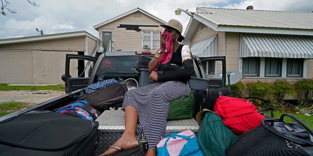 Rakisha Murray cries in relief as she arrives to see her mother's home largely undamaged, after she returned from evacuation with her mother and other family in Lake Charles, La., in the aftermath of Hurricane Laura, Sunday, Aug. 30, 2020.