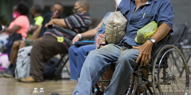 Southwest Louisiana residents wait for buses at Burton Coliseum in Lake Charles, La. to be evacuated to a shelter in Alexandria, La., Tuesday. (Rick Hickman/American Press via AP)