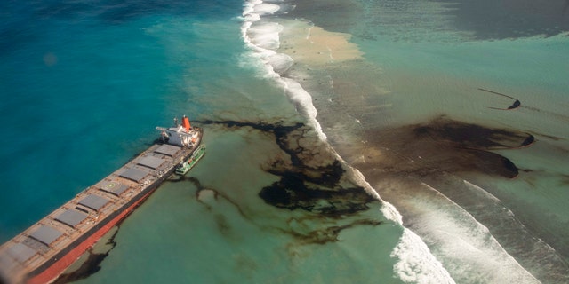 This photo provided by the French Defense Ministry shows oil leaking from the MV Wakashio, a bulk carrier ship that recently ran aground off the southeast coast of Mauritius, on Sunday.