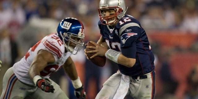Tom Brady is sacked by the New York Giants Michael Strahan during the 2008 Super Bowl at Phoenix Stadium.