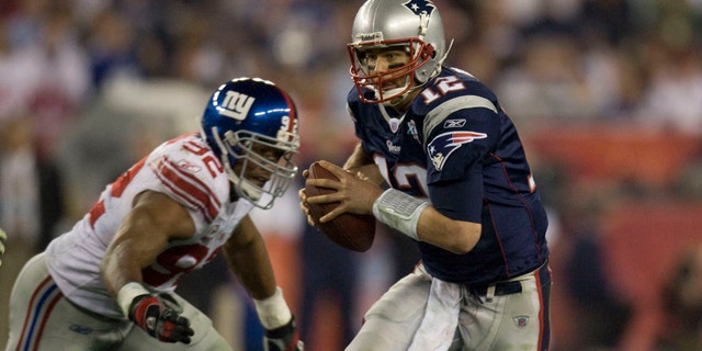 Tom Brady is sacked by the New York Giants Michael Strahan during the 2008 Super Bowl at Phoenix Stadium.