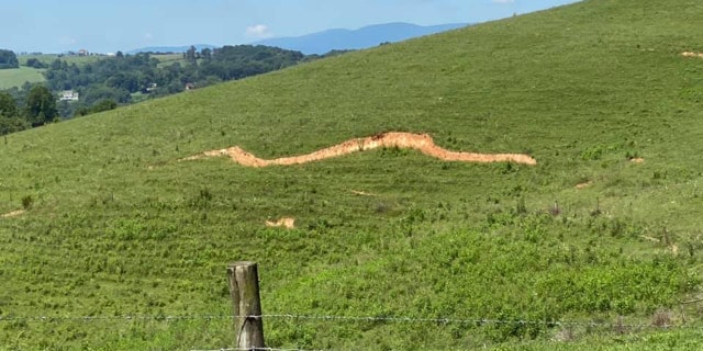 A large crack can be seen in a hillside in Sparta, N.C. after an earthquake on Sunday.