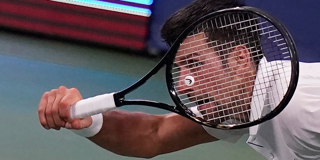 Novak Djokovic of Serbia returns a serve to Roberto Bautista Agut of Spain during the semifinals at the Western & Southern Open tennis tournament Friday, Aug. 28, 2020, in New York. (AP Photo/Frank Franklin II)
