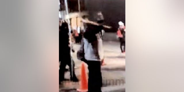 Images capture a bat-wielding suspect accused of striking a federal officer during a July 27 protest in downtown Portland.