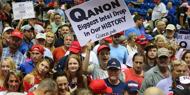 Trump supporters displaying QAnon posters appeared at President Donald J. Trumps Make America Great Again rally Tuesday, July 31, 2018 at the Florida State Fair Grounds in Tampa Florida.  (Photo by Thomas O'Neill/NurPhoto via Getty Images)