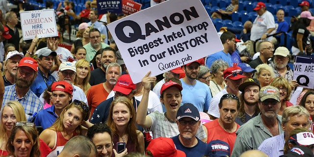 Trump supporters displaying QAnon posters appeared at President Donald J. Trumps Make America Great Again rally Tuesday, July 31, 2018 at the Florida State Fair Grounds in Tampa Florida. (Photo by Thomas O'Neill/NurPhoto via Getty Images)
