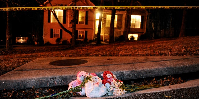 A makeshift memorial is shown outside a home in a suburban neighborhood in Douglasville, Georgia.