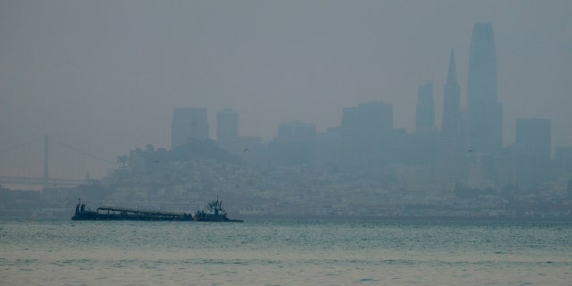 The San Francisco skyline is barely visible through smoke from wildfires Wednesday, Aug. 19, 2020, in this view from Sausalito, Calif.