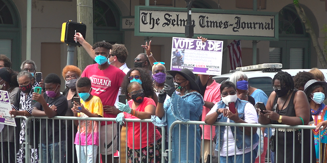 Hundreds gathering to witness John Lewis cross the Edmund Pettus Bridge for a final time last month.