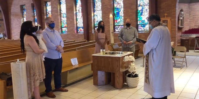 Julia Vicidomini and her family attend her daughter's baptism at Christ the King Church in Hillside, N.J.