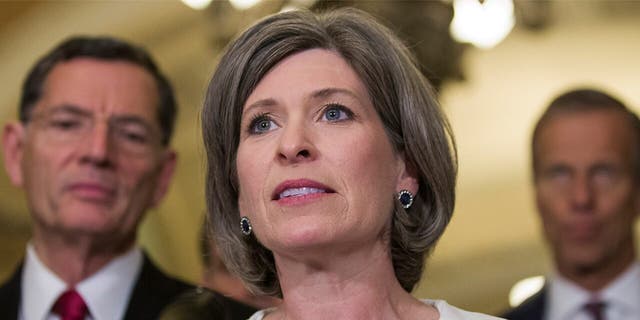 Sen. Joni Ernst, R-Iowa, speaks during a media availability after their policy luncheon on Capitol Hill, Tuesday, May 7, 2019, in Washington. Ernst is accompanied by Sen. John Barrasso, R-Wyo., left, and Sen. John Thune, R-S.D. (AP Photo/Alex Brandon)