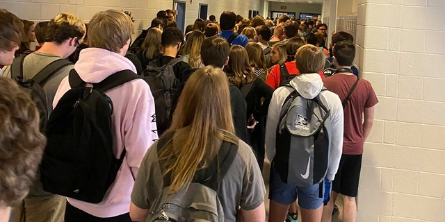 In this photo posted on Twitter, students crowd a hallway, Tuesday, Aug. 4, 2020, at North Paulding High School in Dallas, Ga. The 30,000-student suburban Paulding County school district in suburban Atlanta resumed classes Monday with 70% of students returning for in-person classes five days a week, days after the principal at North Paulding announced some members of the football team had tested positive for COVID-19. The district says it is encouraging mask use, but isn't requiring it. (Twitter via AP)