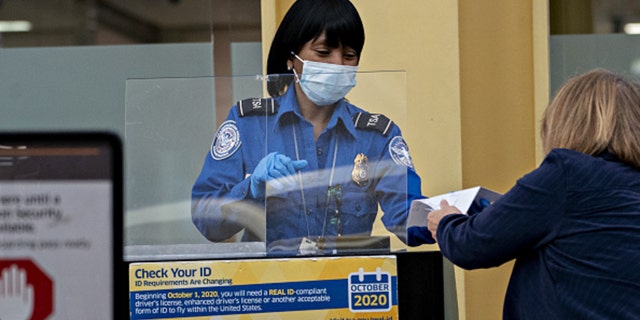 A Transportation Security Administration (TSA) screening a traveler at Ronald Reagan National Airport (DCA) in Arlington, Virginia, on Tuesday, June 9, 2020. (Andrew Harrer/Bloomberg via Getty Images)
