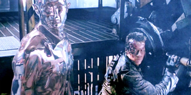 The film "Terminator 2: Judgment Day", directed by James Cameron.  Seen here from left, the T-1000 Terminator, in liquid metal form, and Arnold Schwarzenegger (as the T-800 Terminator).  Screenshot.  Paramount Pictures.