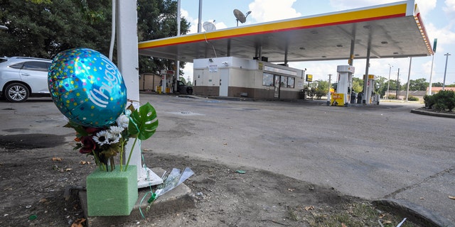 A makeshift memorial on the ground at a Shell station Saturday in Lafayette, La., for 31-year-old Trayford Pellerin.