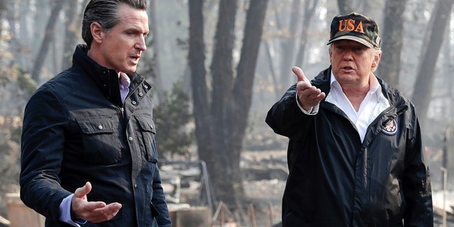 In this Nov. 17, 2018 photo, President Trump talks with then Gov.-elect Gavin Newsom, left, during a visit to a neighborhood impacted by the wildfires in Paradise, Calif. (AP Photo/Evan Vucci, File)