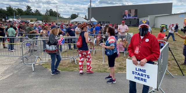 Supporters of President Trump wait in line ahead of Friday evening's event at a hangar adjacent to Manchester-Boston Regional Airport, on August 28, 2020