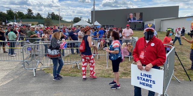 Supporters of President Trump wait in line ahead of Friday evening's event at a hangar adjacent to Manchester-Boston Regional Airport, on August 28, 2020