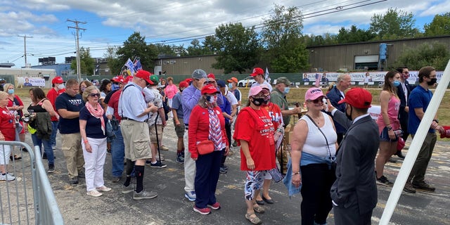 Supporters of President Trump wait in line for a temperature check before as they arrive for the president's speech in Manchester, New Hampshire, on Friday, August 28, 2020.