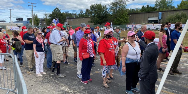 Supporters of President Trump wait in line for a temperature check before as they arrive for the president's speech in Manchester, New Hampshire, on Aug. 28.