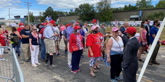 Supporters of President Trump wait in line for a temperature check before as they arrive for the president's speech in Manchester, New Hampshire, on Friday, August 28, 2020.