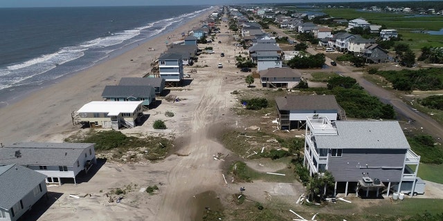 Oak Island sustained wind and flood damage caused by Hurricane Isaias leaving the streets strewn with debris and covered with more than a foot of sand in areas close to the beach Tuesday, August 4, 2020, in North Carolina.