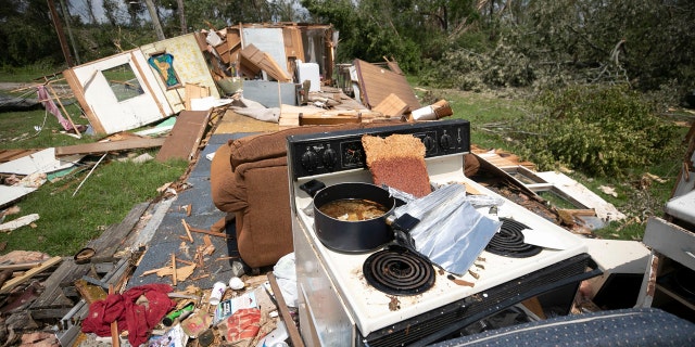 A stove with a pot still on a burner remains intact, while the rest of the mobile home was destroyed by a tornado, spawned by Hurricane Isaias, on Morning Road on Wednesday, August 5, 2020 in Bertie County, N.C.