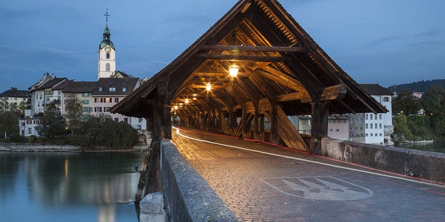 Covered bridge over Aare river in Olten at dawn. (Photo by: Loop Images/Universal Images Group via Getty Images)
